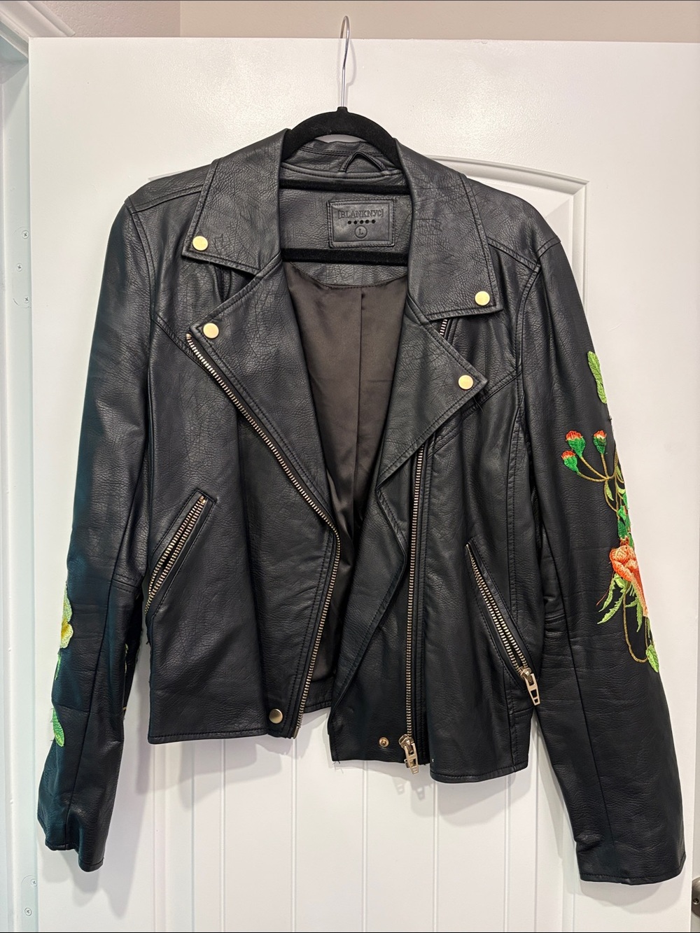 Blank NYC Black Faux Leather Moto Jacket with Floral Sleeve Embroidery